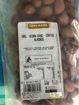 organic vegan chocolate coated almonds (displayed on the label as ORG. VEGAN CHOC. COATED ALMONDS).